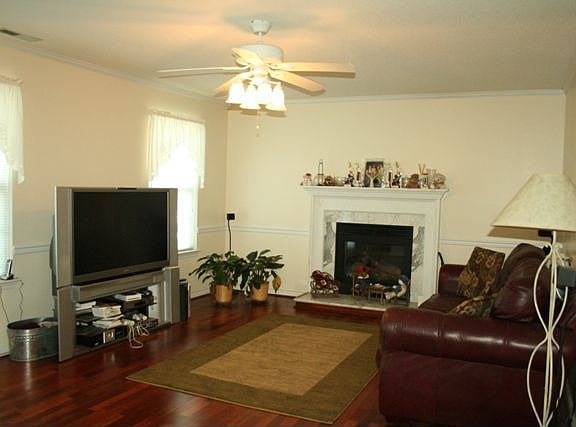 Family room with gas fireplace and wood floors