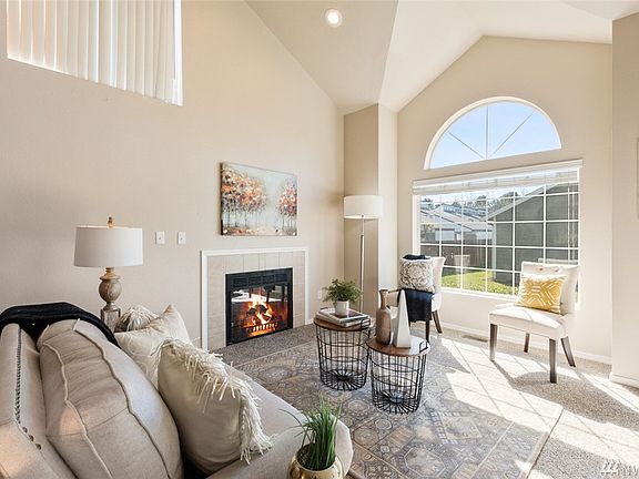 The living room is a beautiful welcoming area, made cozy by the gas fireplace. 