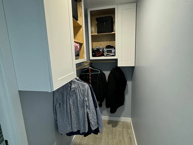 master closet with closed and open shelving and hanging bars