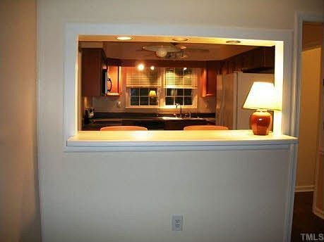 View from family room into the kitchen; features a bar between both rooms.