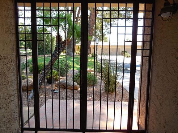 Custom iron gates opens to Courtyard