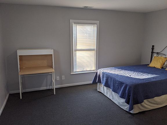 Large bedroom has carpet and closet