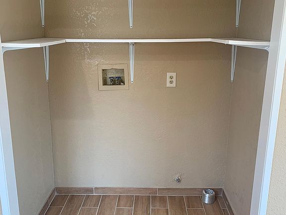 Room with hookups for washer and dryer.