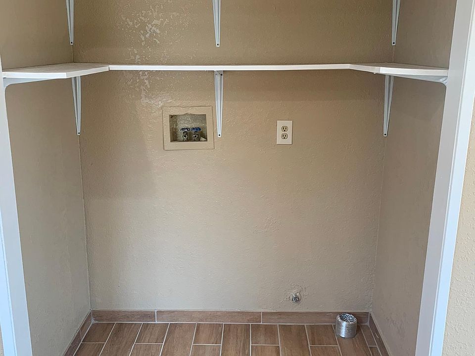 Room with hookups for washer and dryer.