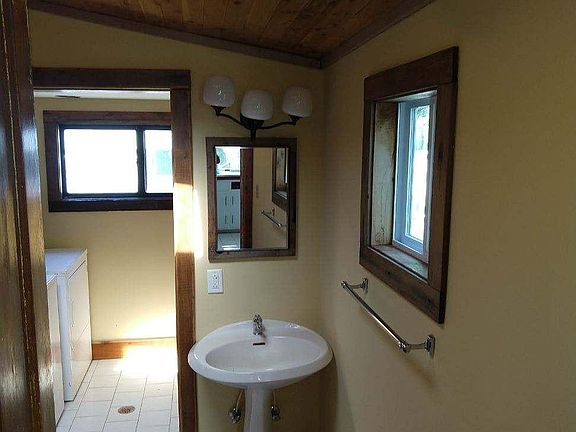 Bathroom leads to sunny laundry room.