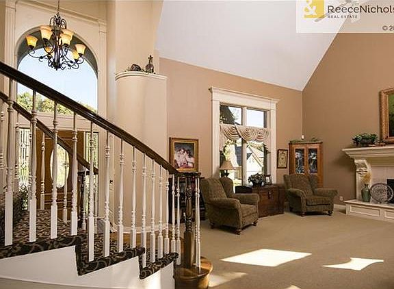 Beautiful entryway and another view of the living room with beautiful fireplace and tall ceilings.