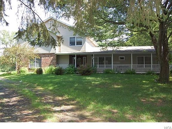 Beautiful wrap around driveway with mature trees brings you to the home.