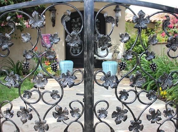 Gorgeous iron gates and front door with grapes and leaves