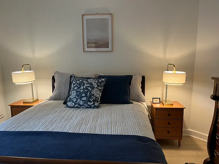 Master bedroom has new queen mattress and box spring, lights and end tables. Storage includes large bureau, closet and a storage wall with drawers.