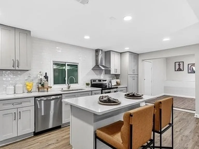 Updated kitchen with a center island, ample cabinetry, and stainless steel appliances, plus bar seating for easy meals.