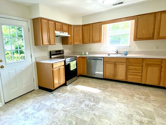 Kitchen with new stove and dishwasher