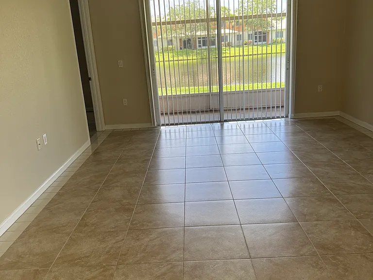 The living room faces a screened patio looking onto the lake.