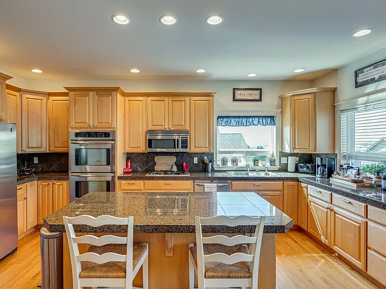 Gas stove, double oven, microwave, island/bar, LOTS of cabinet and counter space
