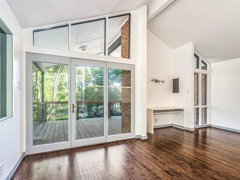 Interior space featuring extensive glazing, a wooden deck, and a built-in desk