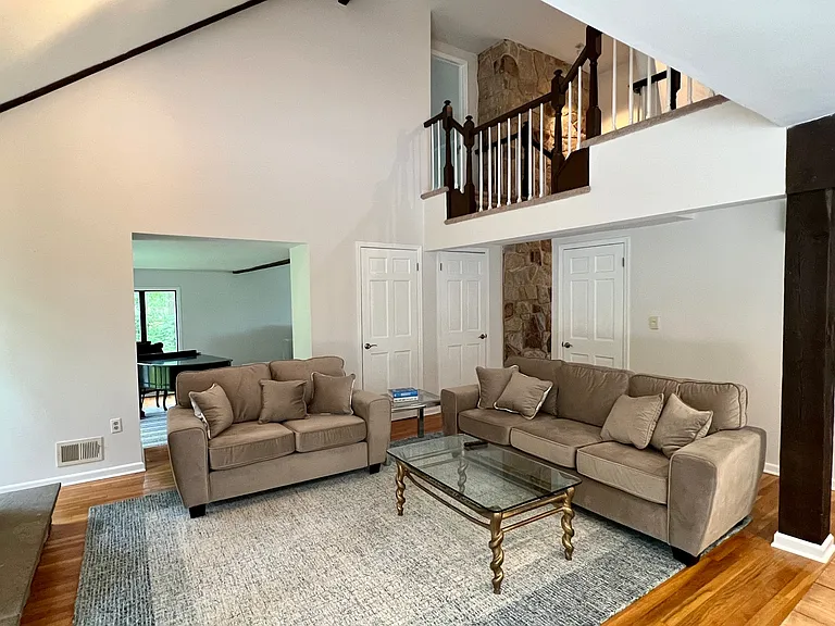 Another view of keeping/family room. Fireplace is to the left. Shot show upper level connecting balcony between the bedrooms