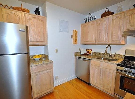 New Eat-in-Kitchen with Granite Counters and Stainless Steel Appliances including a dishwasher, range and refrigerator.