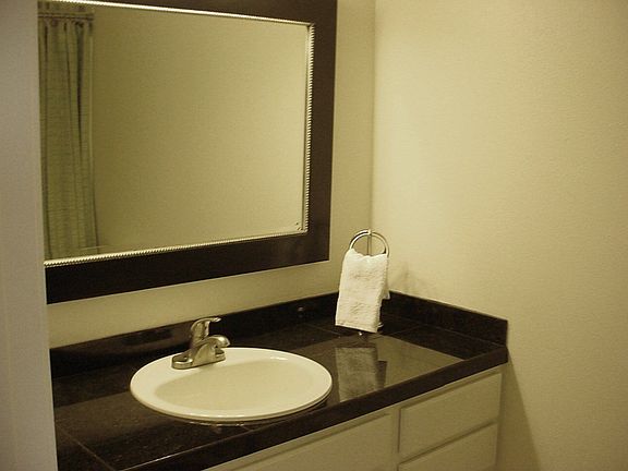 Another bathroom with granite counter top with new cabinte