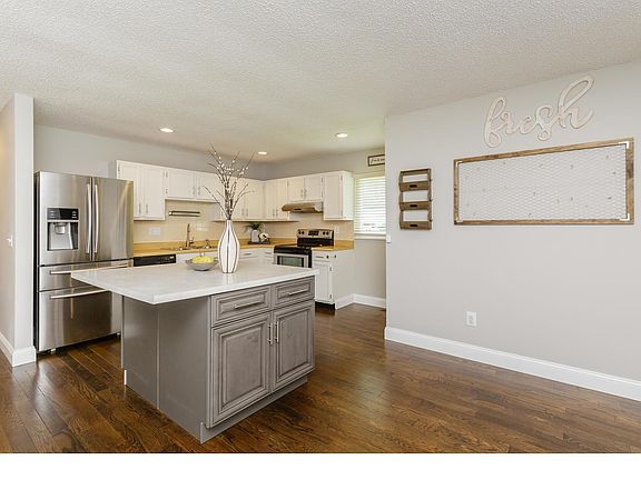wood floors and stainless steel appliances