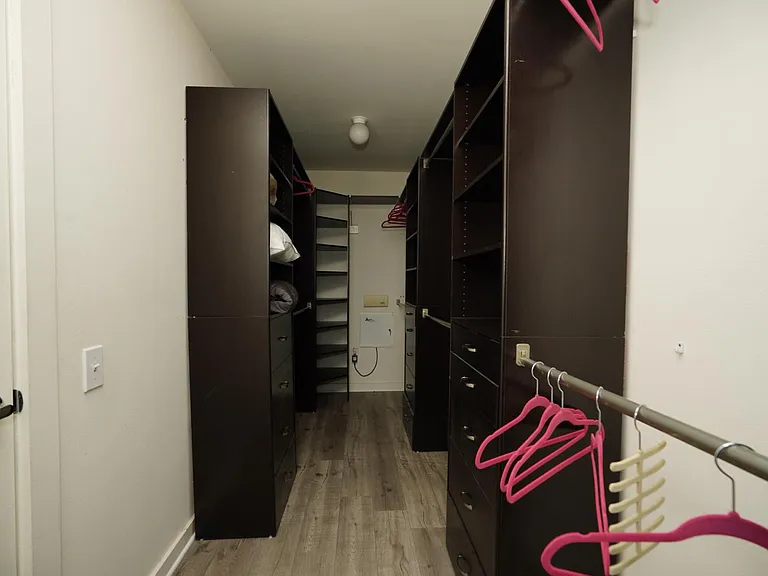 Walk in closet with custom built cabinets