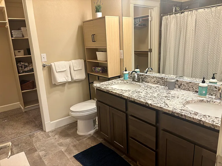 Primary bath features granite countertops, shower and large walk in closet