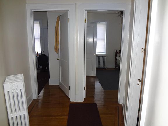 Hall leads to bedrooms, bathroom