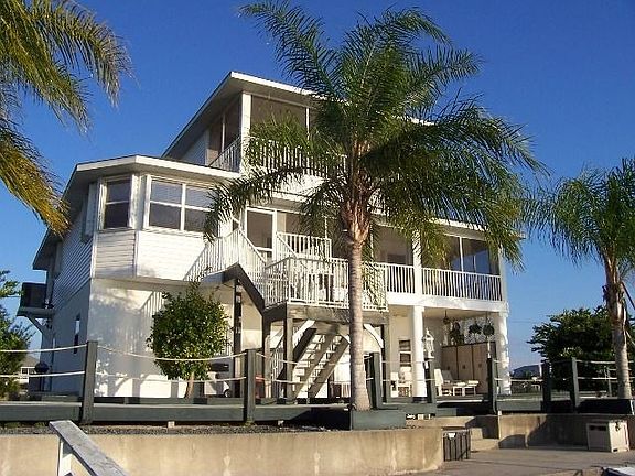 Queen palms line the water side.