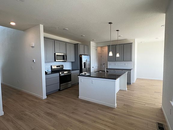 Kitchen with Island Grey cabinets GE appliances