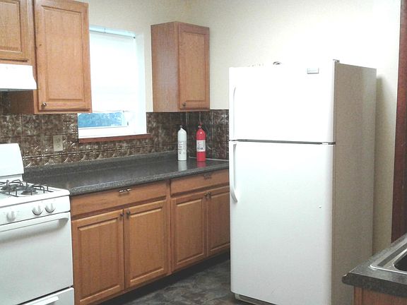 Kitchen, stove (gas) and refrigerator.