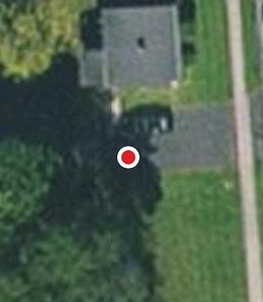 Aerial view of house and large yard with 2 car driveway.