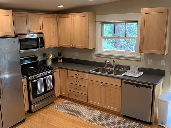 Kitchen with gas range and stainless appliances.