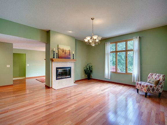 Large living room with tall windows and a beautiful view.  2 way fireplace.