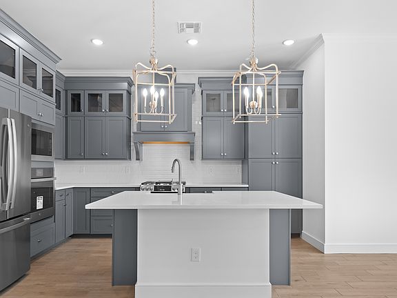 Kitchen with stacked glass-front upper cabinets