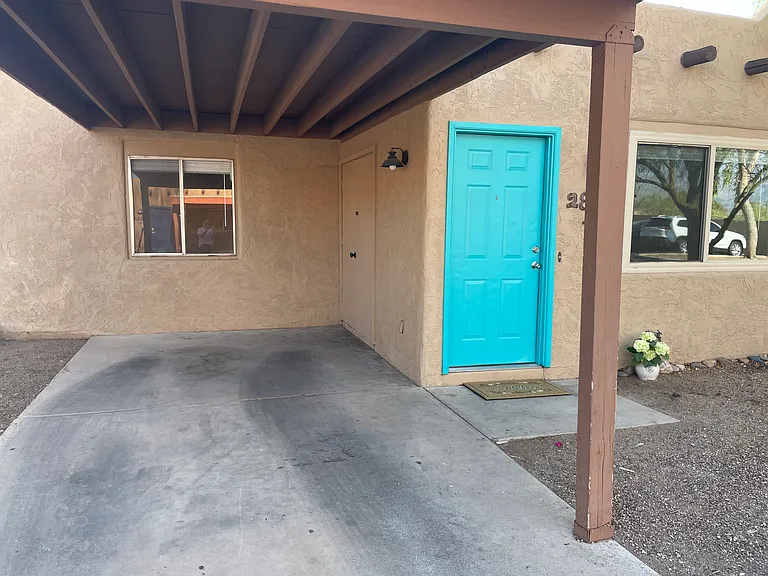 Covered carport and locked laundry closet on right