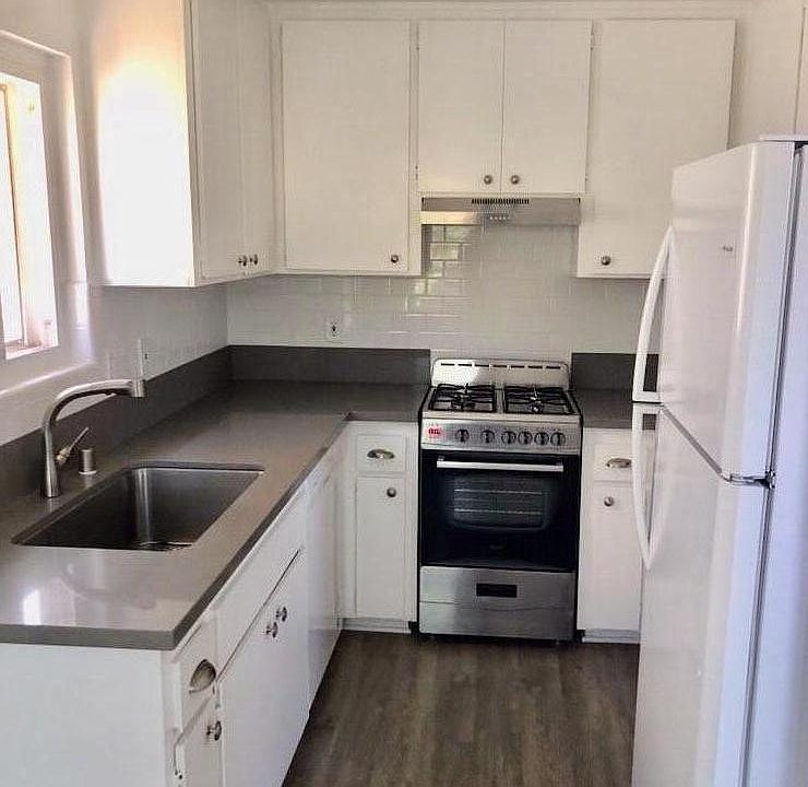 Kitchen includes dishwasher, refrigerator and new range.