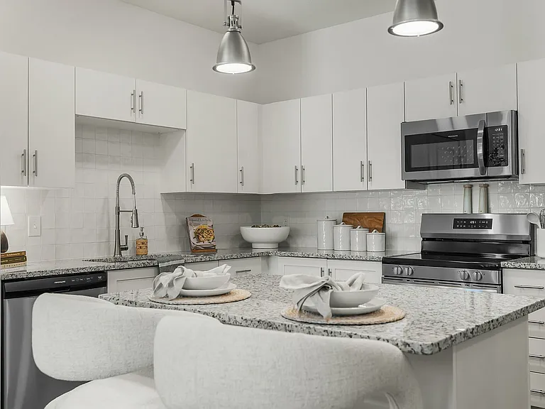 Experience the elegance of this sleek modern kitchen, perfect for culinary enthusiasts.
