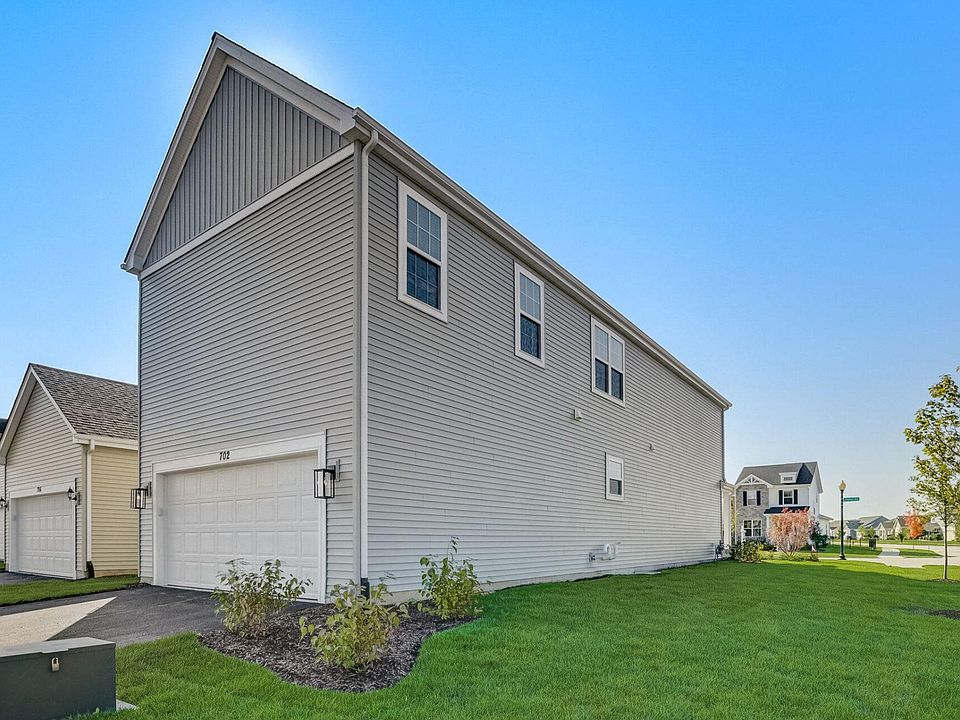2 Car attached Garage is accessible via a drive at the back of each Village Home