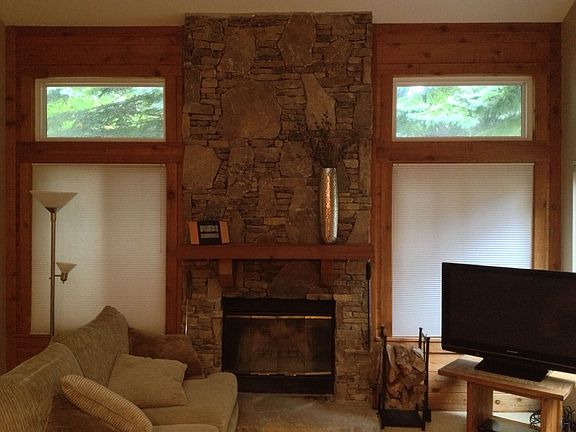 Beautiful local stone highlights the wood burning fireplace 
