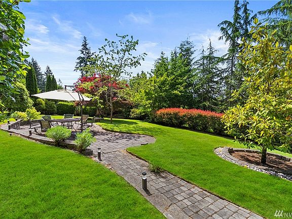 This is the beautifully manicured yard with a lighted path to your peaceful patio area and pond