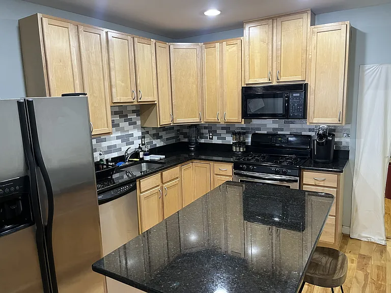 Kitchen area with applicances and storage