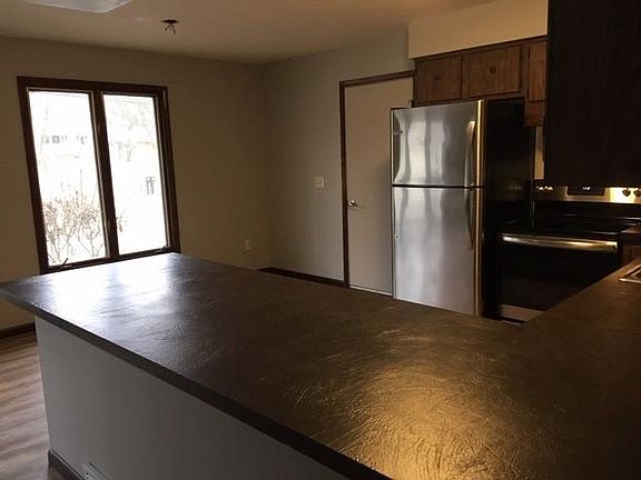 Additional kitchen view showing dining area and door to attached garage.