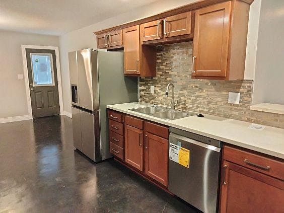Kitchen features marble countertops and stainless steel appliances