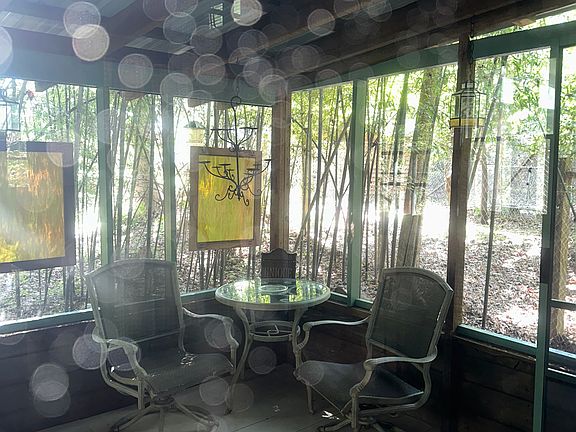 Front screened in porch facing towards woods.