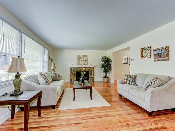 Living rm: gleaming hardwoods & a stone fireplace