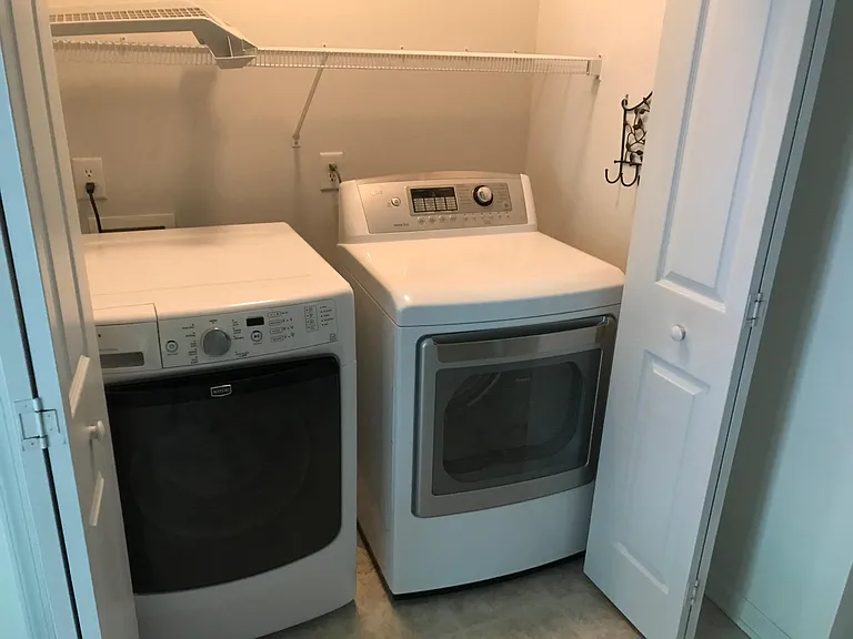 Laundry room with washtub in back mudroom. Entry is off screened porch/deck area