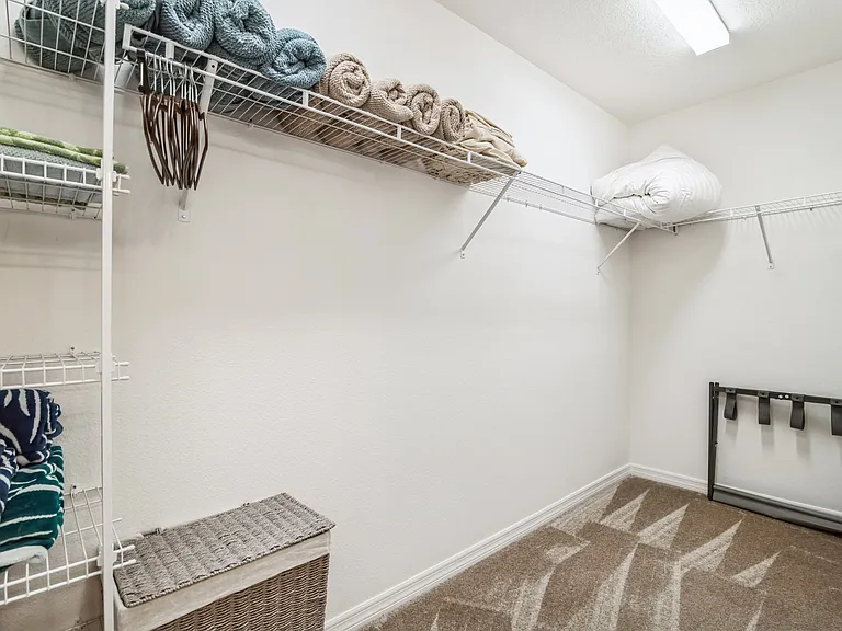 Master Bedroom Walk-in Closet with Shelving and Clothing Storage Area.