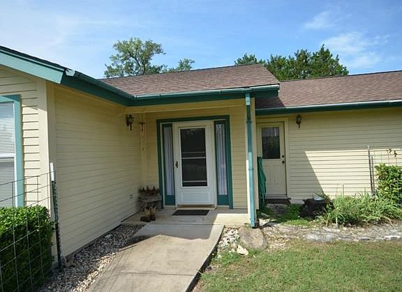Greet your guests from this cozy covered porch.