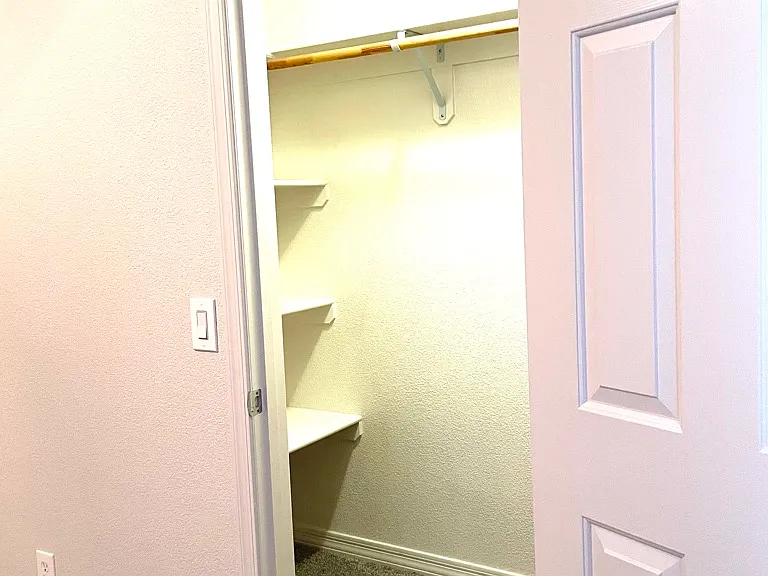 primary bedroom walk in closet left side