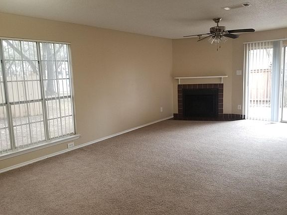 Carpet and fireplace in living area on this unit