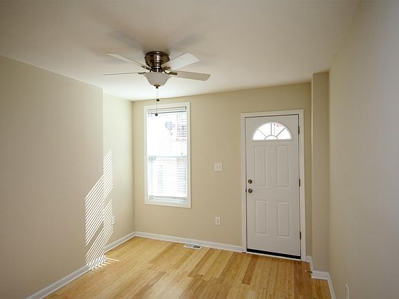 Living room in front of house with bamboo floors and ceiling fan