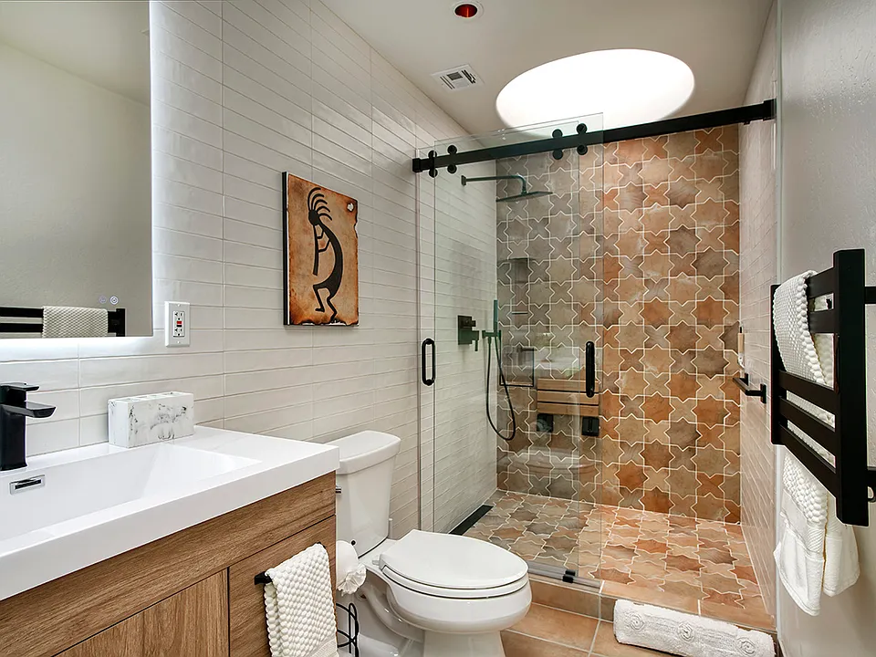 Ensuite Shower features skylight, grab bar, flip down seat and hand spray wand.